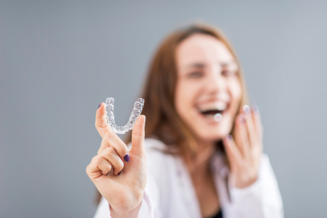 Rider Family Dentistry Dentist in Cherokee, IA Beautiful,Smiling,Turkish,Woman,Is,Holding,An,Invisalign,Bracer,In